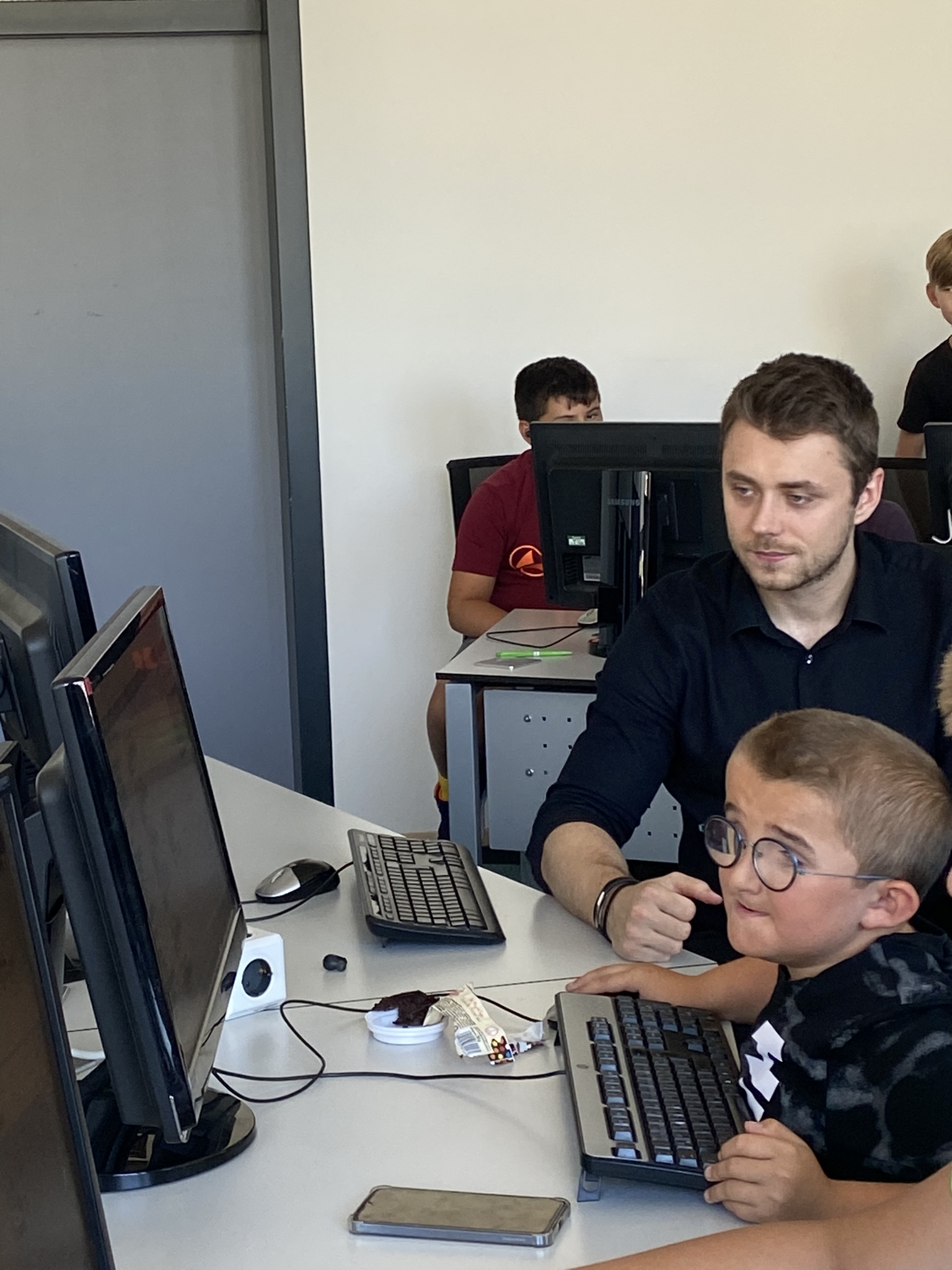 Chris helping a student at the computer at Coding4Kids 2023